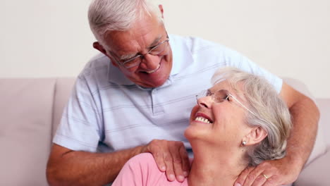 Senior-man-giving-his-wife-a-shoulder-rub