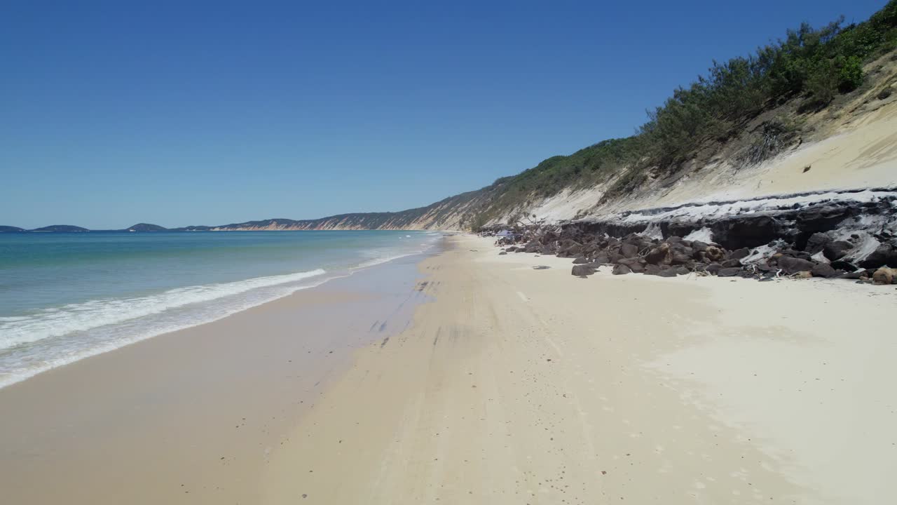arena blanca y océano turquesa en la playa del arco iris, queensland, australia - disparo de drones