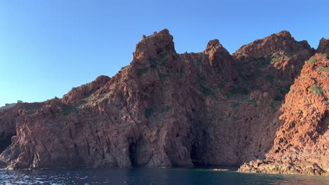 Impressive-Scandola-peninsula-nature-reserve-in-summer-season-as-seen-from-moving-boat,-Corsica-island-in-France