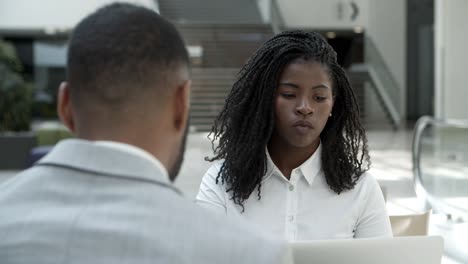 Concentrated-African-American-woman-listening-her-colleague