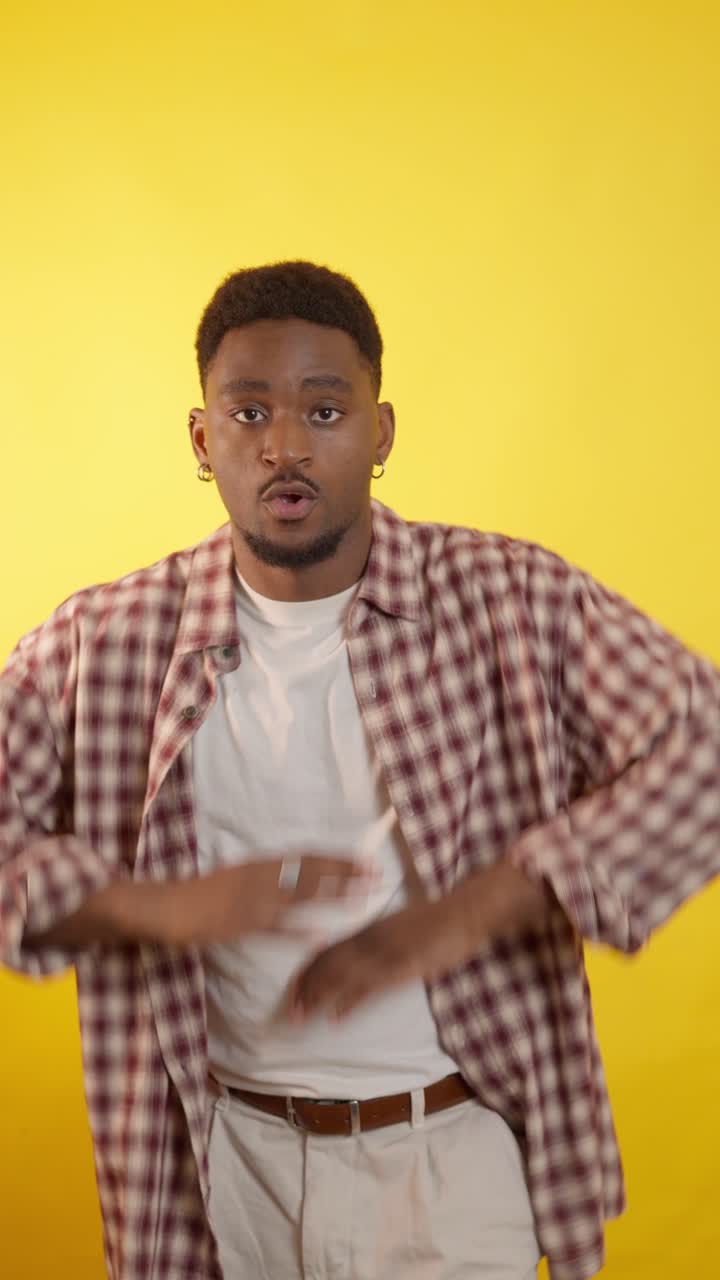 Man in plaid shirt on yellow background
