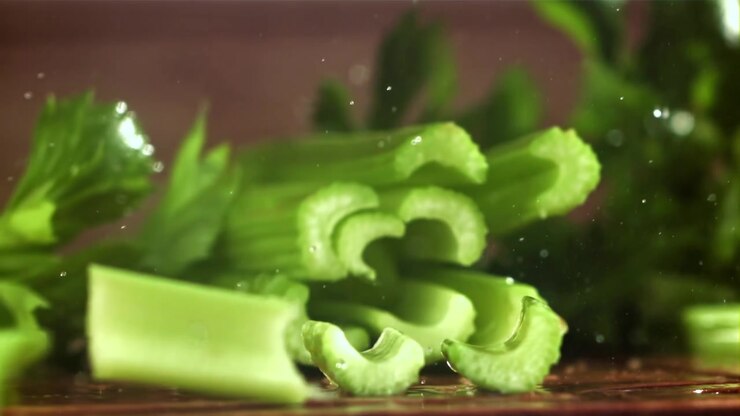 Close-up of Fresh Celery Being Chopped in Slow Motion