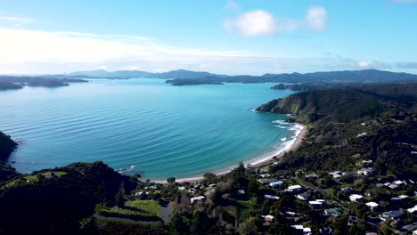 drone view of a bay and a small town on a sunny day in russel, bay of islands, northland, new zealand.