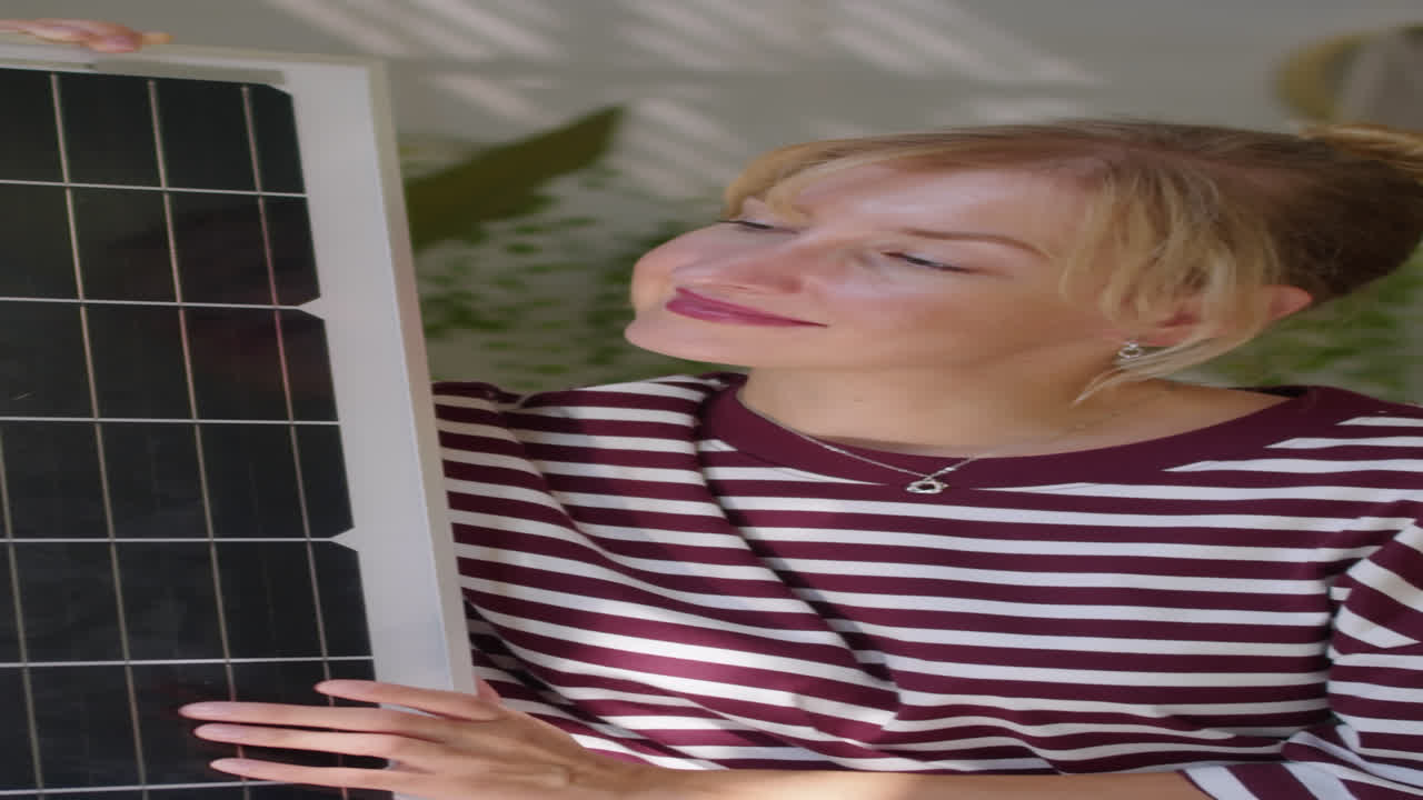 Vertical Portrait of Young Woman Posing near Solar Panel Indoors