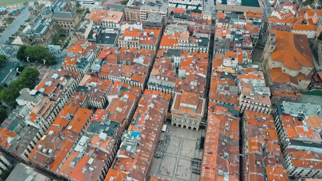 Drone bird's eye view of orange colonial roofs and houses of San Sebastian Spain
