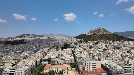 4k aerial drone view of the city of athens in greece on a sunny day going forward