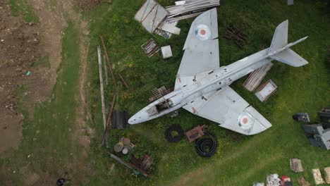 aerial view circling above military hawker hunter wt804 jet on farmland scrap yard