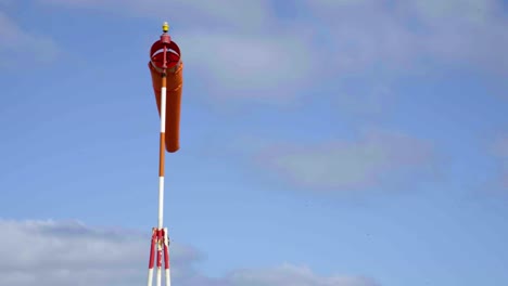 a windsock blowing next to an airport