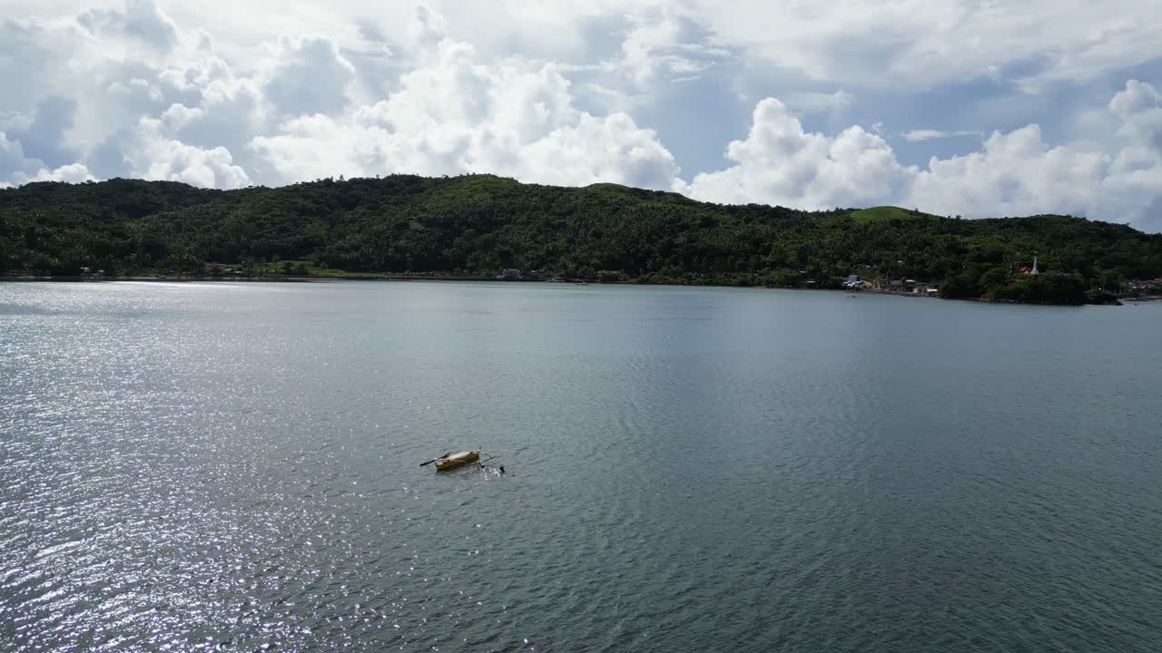 Breathtaking view of traditional Philippine bangka boat floating in the tranquil bay of Baras, Catanduanes