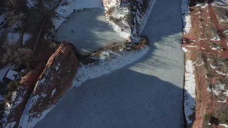 Aerial-bird-eyes-over-frozen-lakes-on-sunny-winter-day