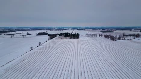 ploughed field snow covered farm in london, canada, farm landscape with aerial drone view 60fps