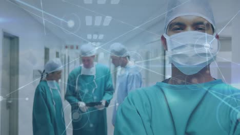 Animation-of-network-of-connections-over-biracial-male-surgeon-in-face-mask