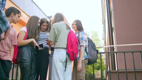 las adolescentes se divierten y conversan usando sus teléfonos móviles