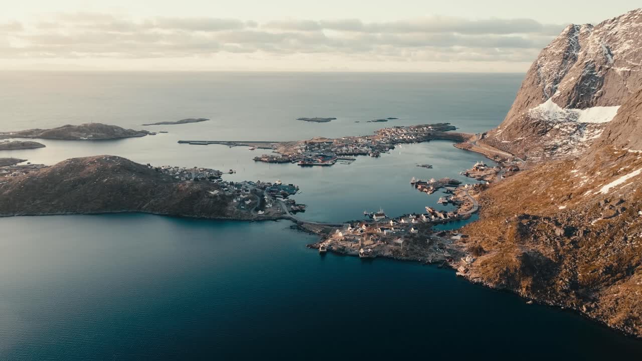 Coastal Village Of Reine Along Calm Blue Waters In Lofoten Islands, Norway. aerial shot