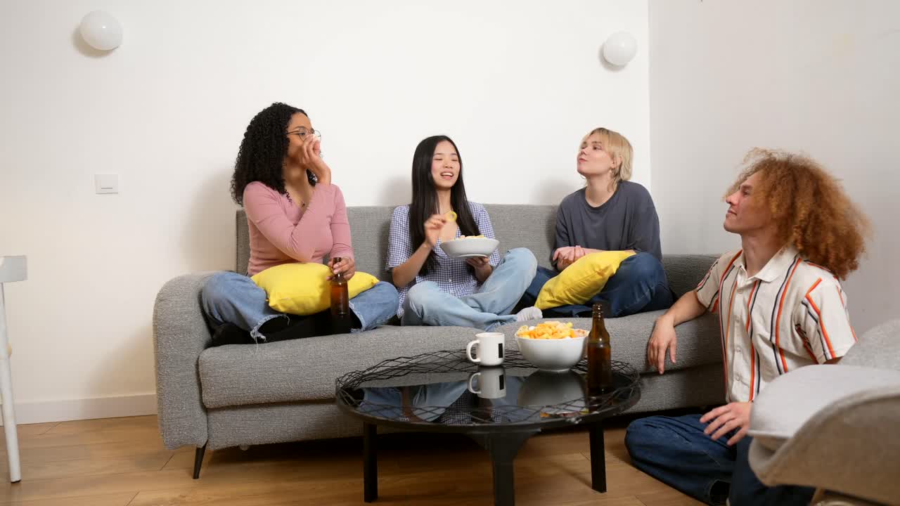 Friends enjoying snacks and drinks while watching TV
