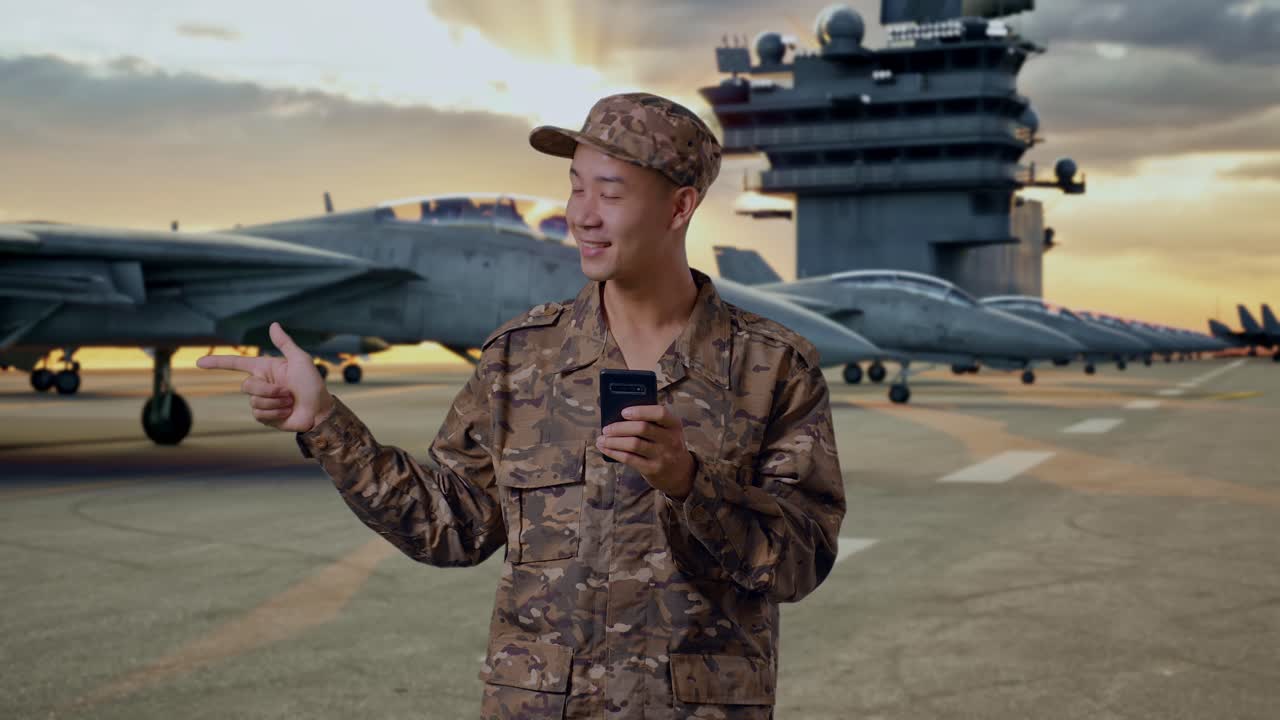 Military Personnel Using Smartphone on Aircraft Carrier Deck
