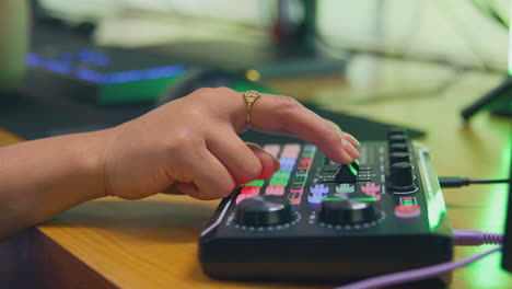 close up of female vlogger using editing console for live stream of channel