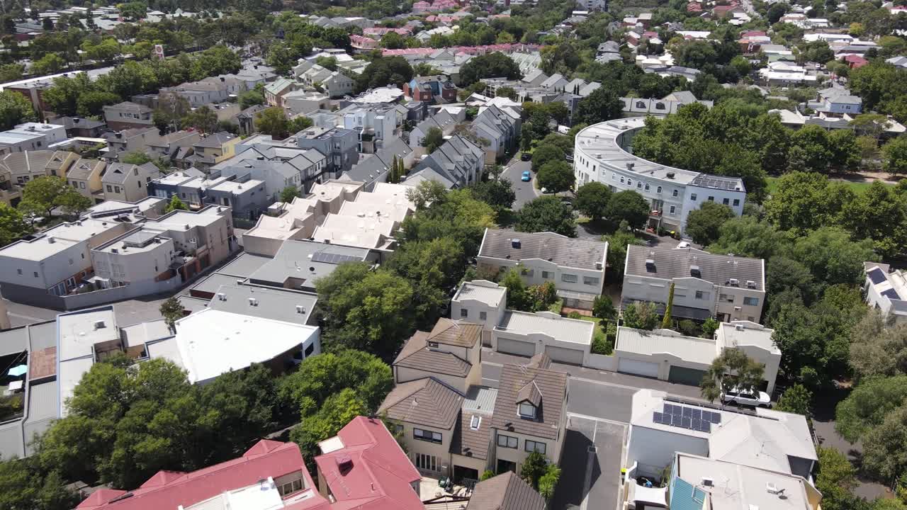 Aerial drone above Kensington suburb with leafy trees on a sunny day