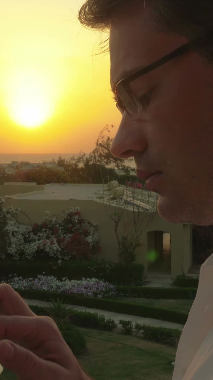 Man watching sunset from balcony