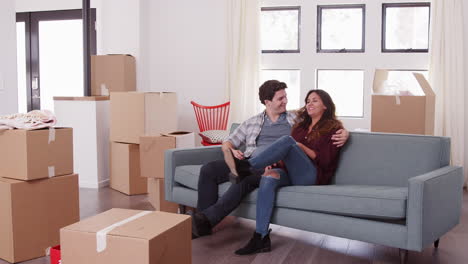 Couple-Carrying-Removal-Boxes-Into-New-Home-On-Moving-Day