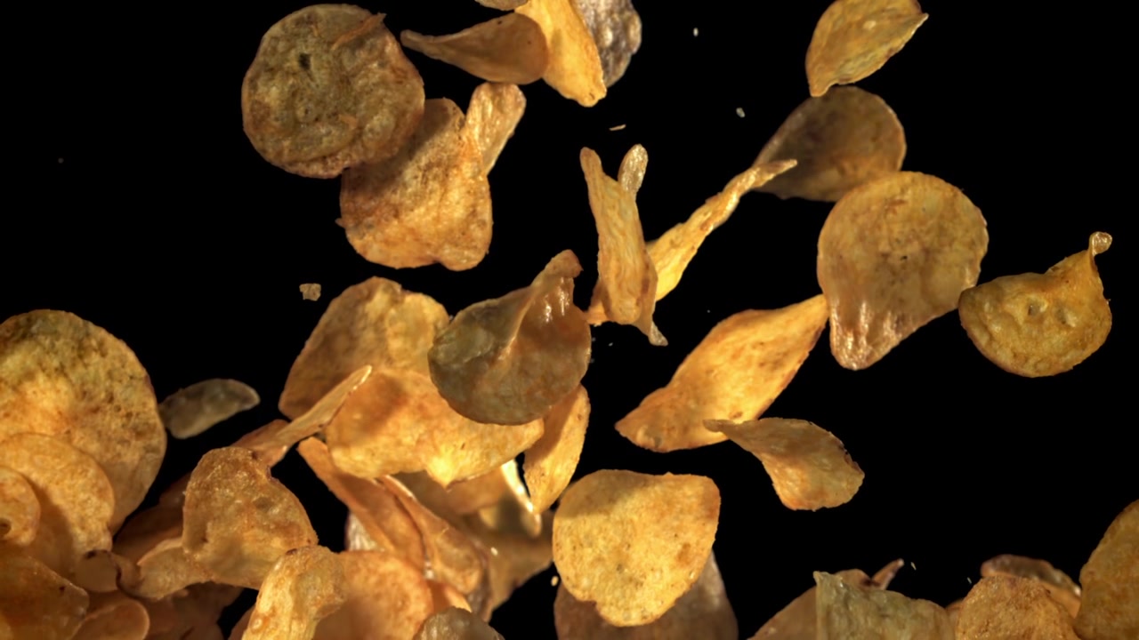 Crispy Potato Chips Falling and Rising in Slow Motion