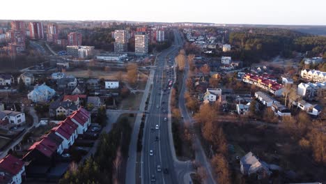 AERIAL-Backwards-Fly-by-over-a-Highway-in-Upper-Vilnius,-Lithuania