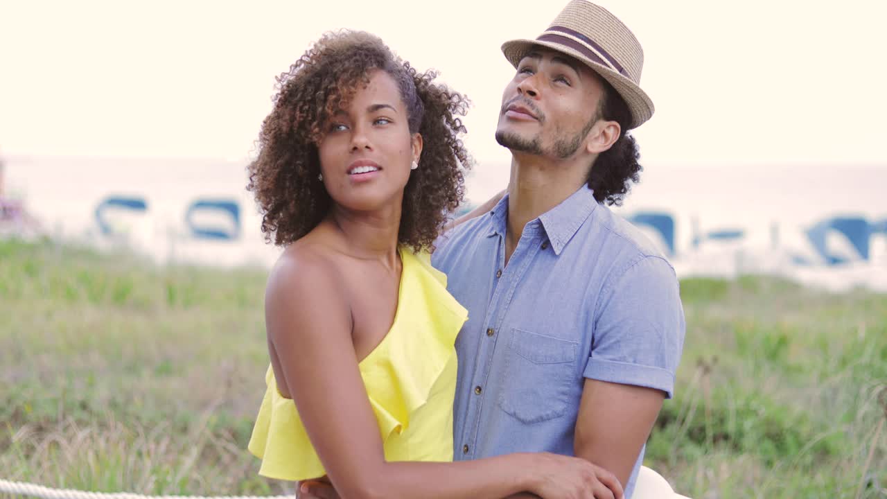 Woman with boyfriend pointing away