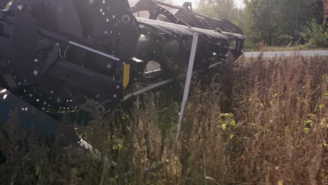 combine harvester harvesting organic soybeans on sunny day slow motion