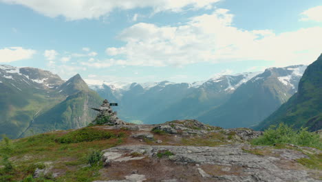 revealing shot of klovane and oldevatnet from mountain peak in olden, norway on a sunny day