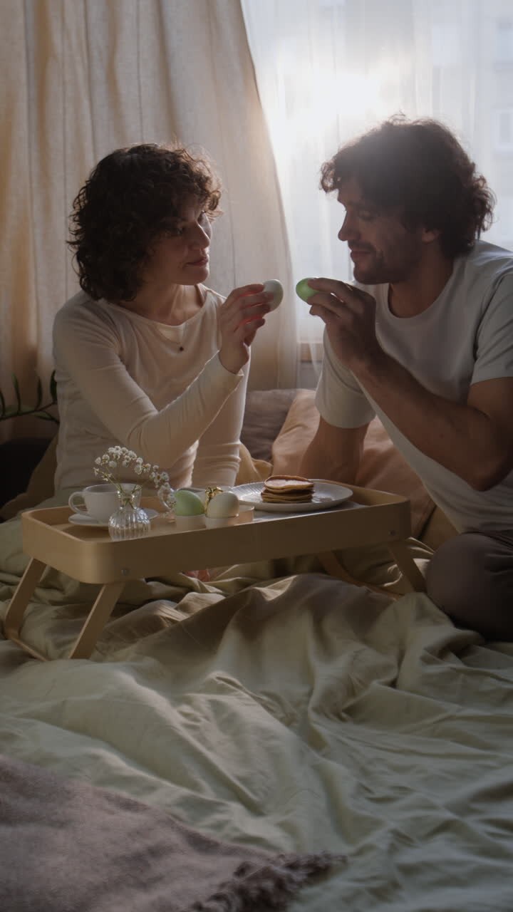 Couple enjoying Easter breakfast in bed