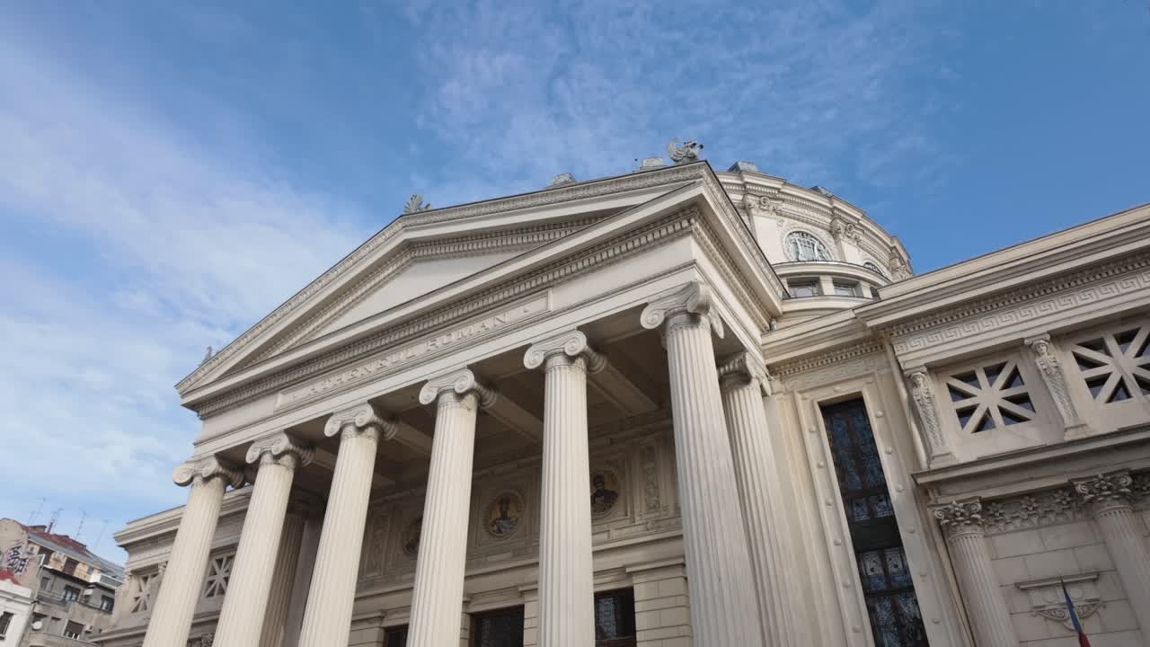Historic neoclassical Athenaeum building under bright blue sky in Bucharest