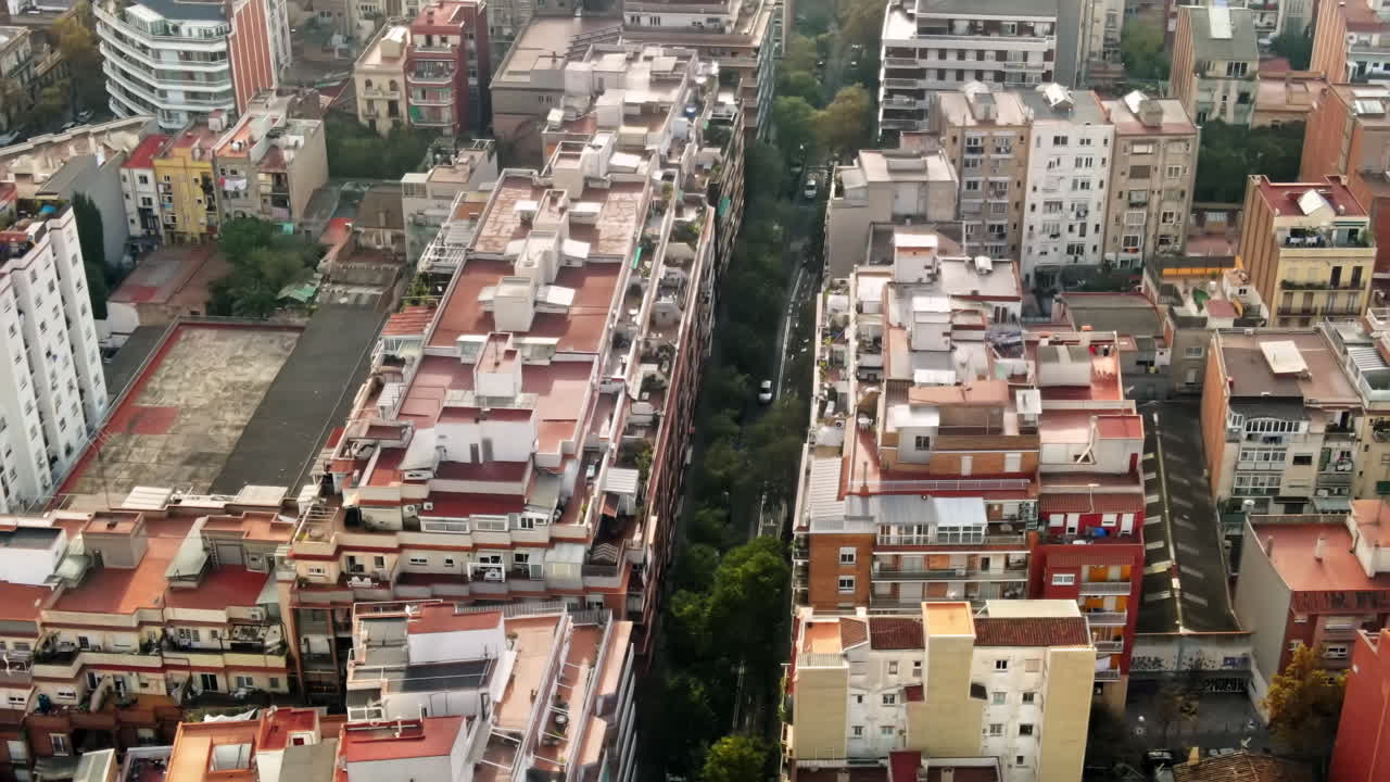 Aerial drone view of Barcelona, Spain. Blocks with multiple residential buildings, road with cars