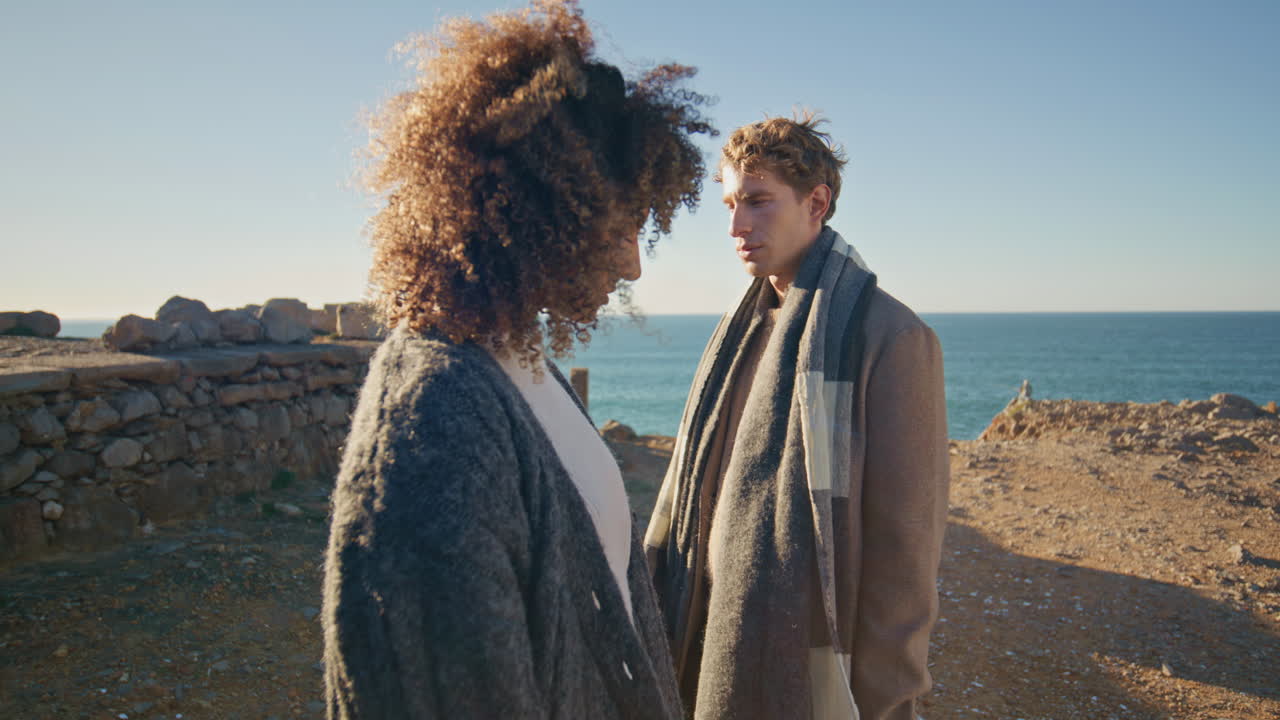 Sad spouses feeling sadness at ocean cliff horizon closeup. Relationship crisis