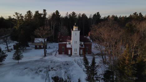 4k drone video of 40 mile point lighthouse in presque isle county in michigan during the winter