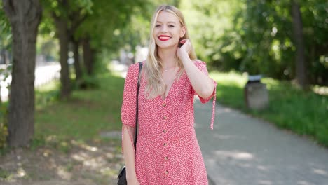 woman in a red floral dress in a park