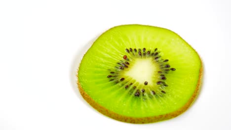 la rebanada de kiwi fresca está girando lentamente en el estudio con los detalles.