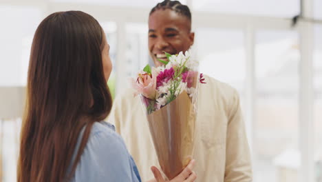 surprise, flowers and couple hug in home to