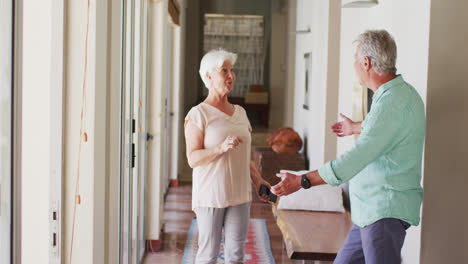 Happy-senior-caucasian-couple-dancing-together-at-home