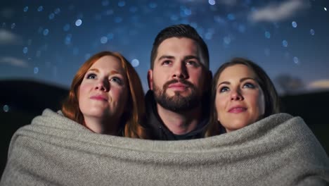 Three Friends Enjoying a Starry Night Under a Blanket, Sharing Moments of Wonder and Connection Amidst a Stunning Celestial Display