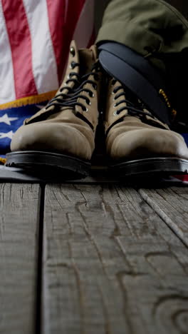 military boots, hat, and flag on wooden table