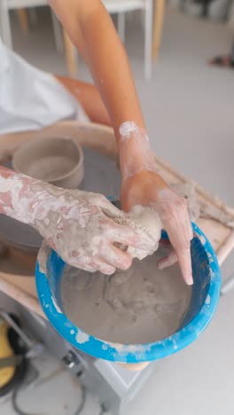 hands working with clay on a pottery wheel
