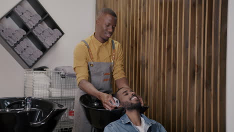 man getting a hair wash at the barber shop