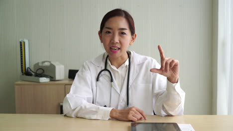 asian female doctor talking in office