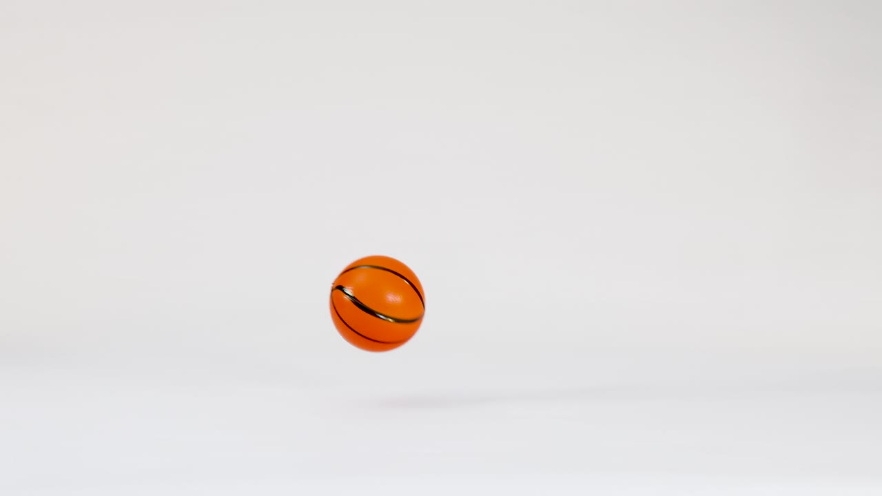 Small Basketball Bouncing and Rolling on White Background