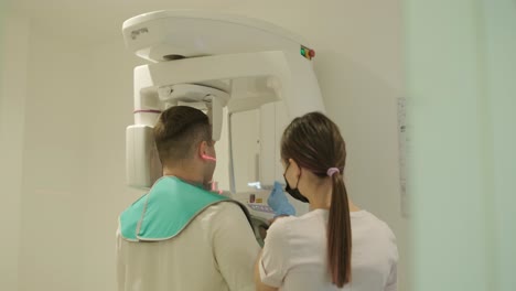 patient undergoing dental x-ray with technician