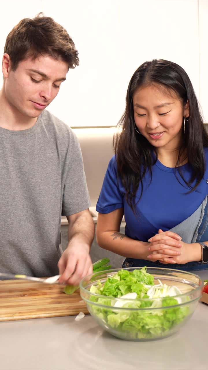 People preparing a salad in the kitchen