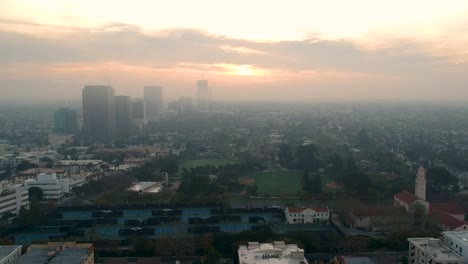 Aerial-pan-down-in-foggy-Los-Angeles-on-a-cloudy,-early-morning