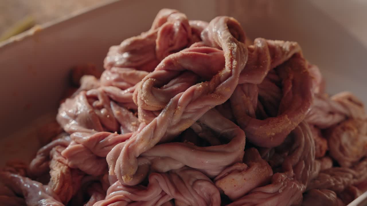 Cleaned pig tripe tightly braided after cornmeal scrubbing in northern Portuguese tradition