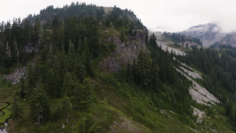 Drone-dolly-above-alpine-lake-pools-and-streams-along-ridgeline-of-forest-in-Northern-Cascade-region