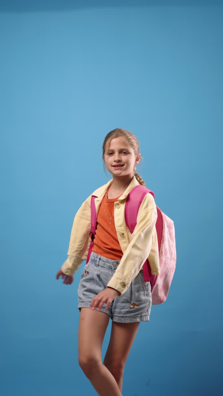 Young Girl with Backpack on Blue Background